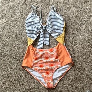 Nani cut out one piece. Striped top with front tie. Orange floral bottom. Size M
